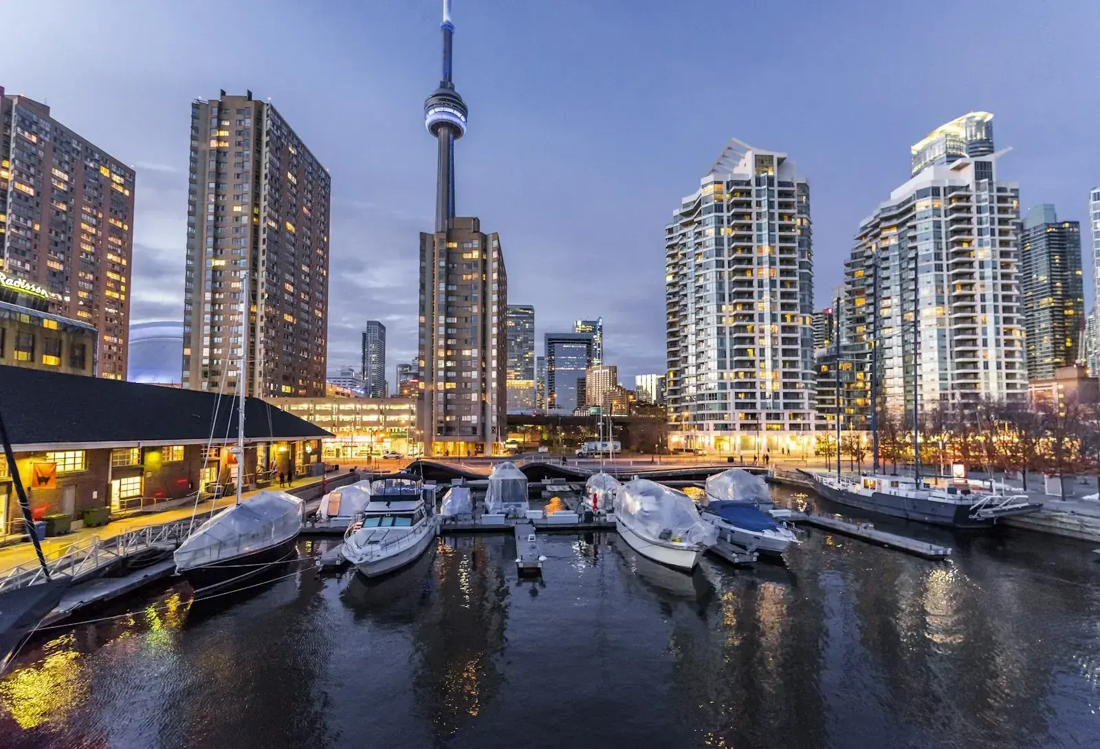 Business professionals against a Canadian city skyline, representing Express Entry category changes for 2026.