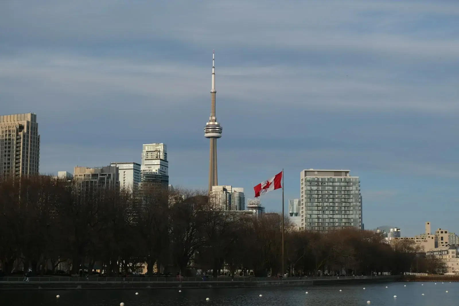 Canadian city skyline symbolising rising Labour Market Impact Assessment processing times for high-wage TFWP work permits.