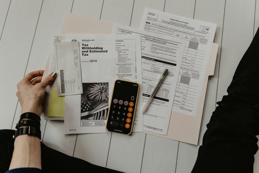 Tax forms and a calculator on a desk during filing