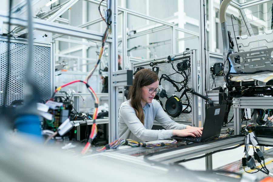 Engineer working at a machine on a production line