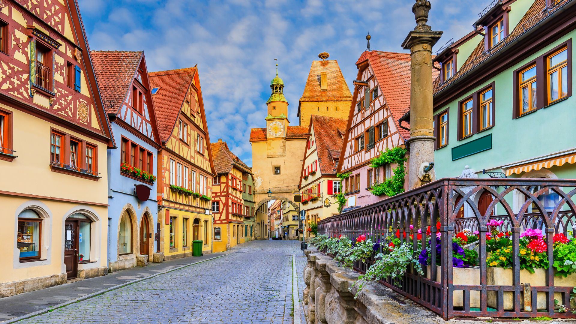 Historic European town street in Rothenburg ob der Tauber, Germany, with half-timbered houses and a clock tower