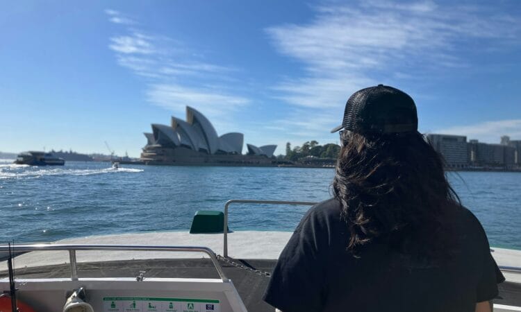 a woman sitting on a boat looking out at the water