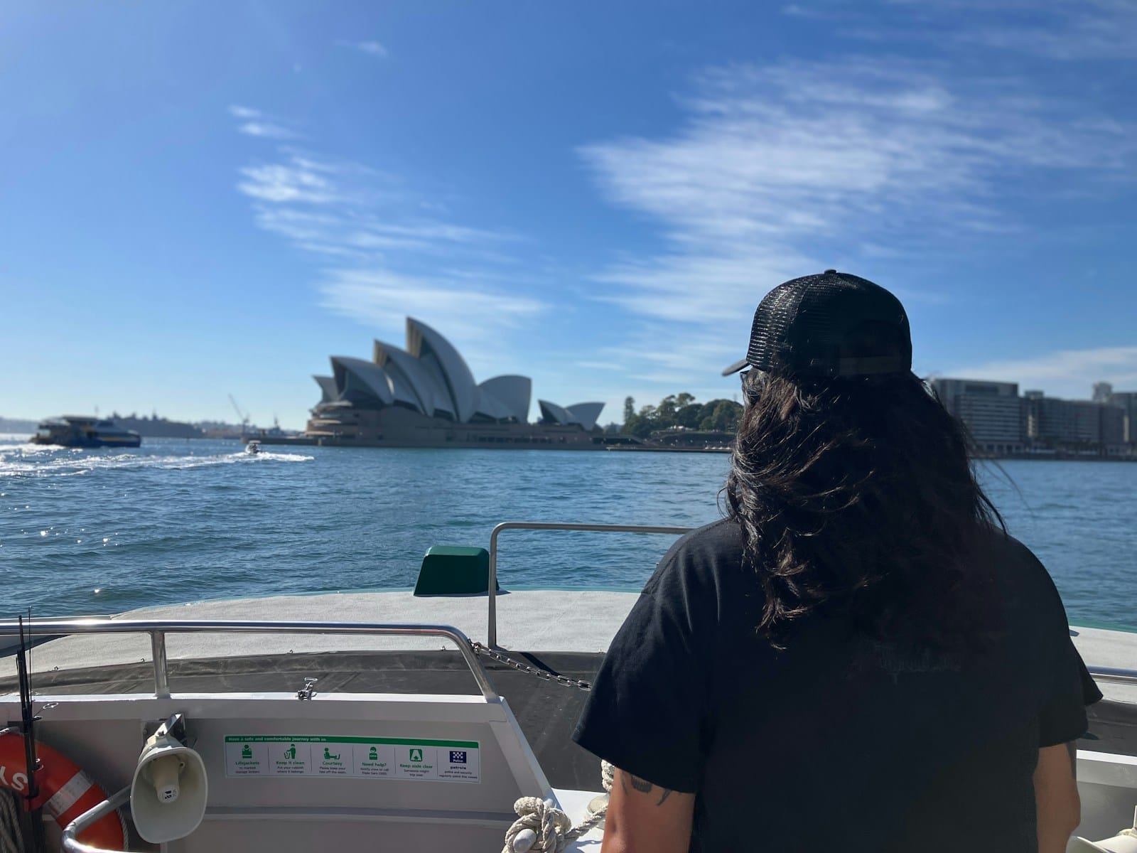 a woman sitting on a boat looking out at the water