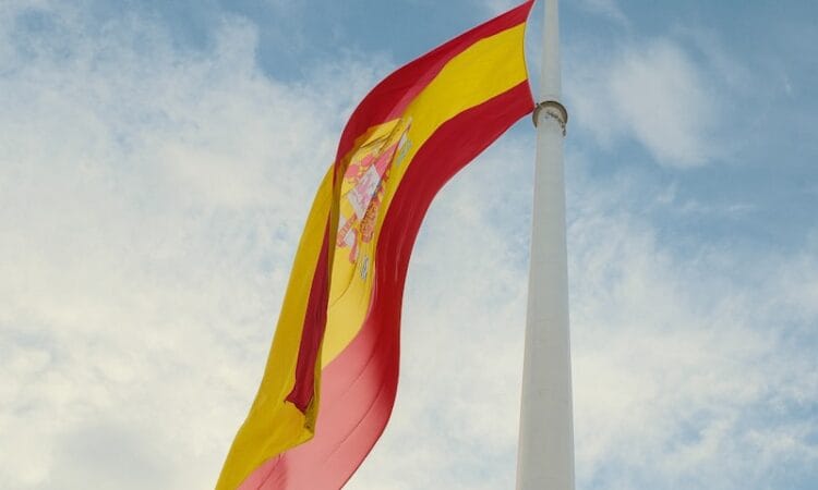 a red and yellow flag flying in the wind