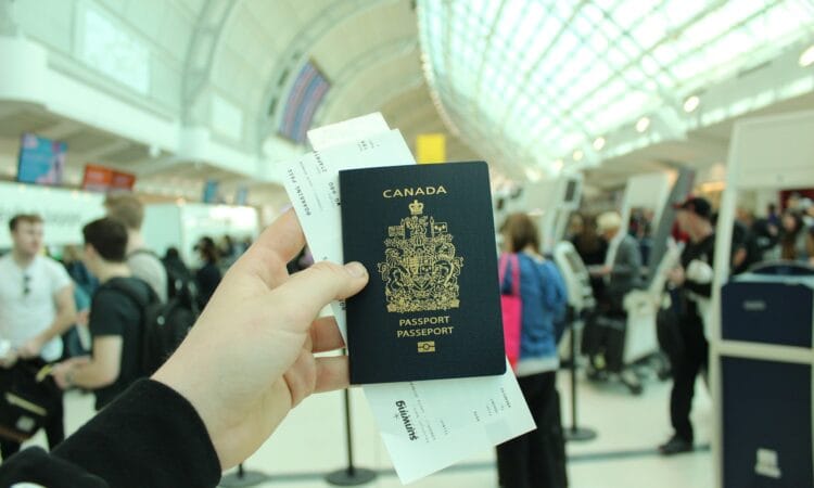 person holding Canada passport