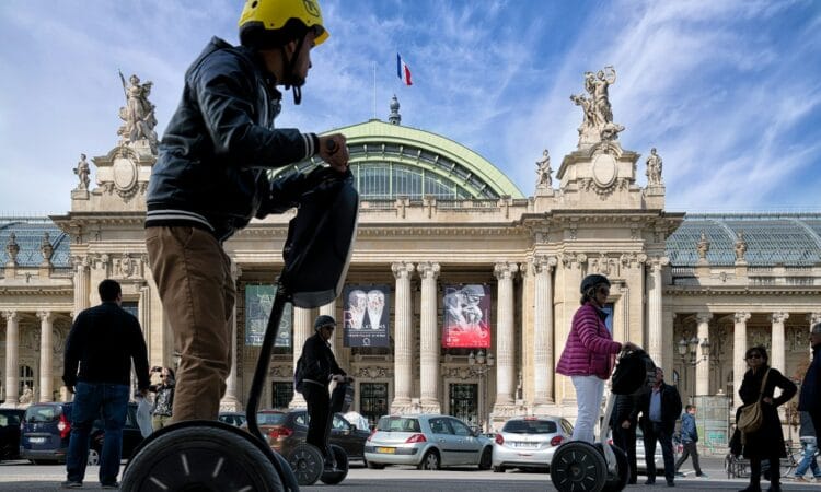 man in black jacket and yellow helmet riding on bicycle during daytime