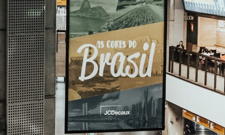 A large poster hanging from the ceiling of a building