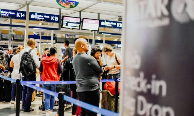 a group of people standing in a line at an airport