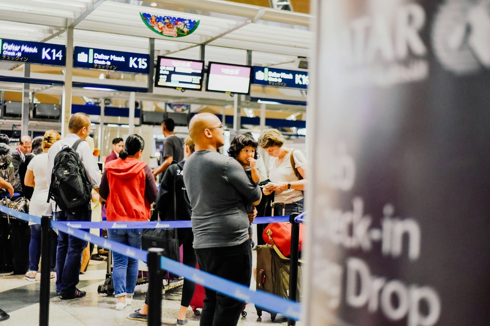 a group of people standing in a line at an airport