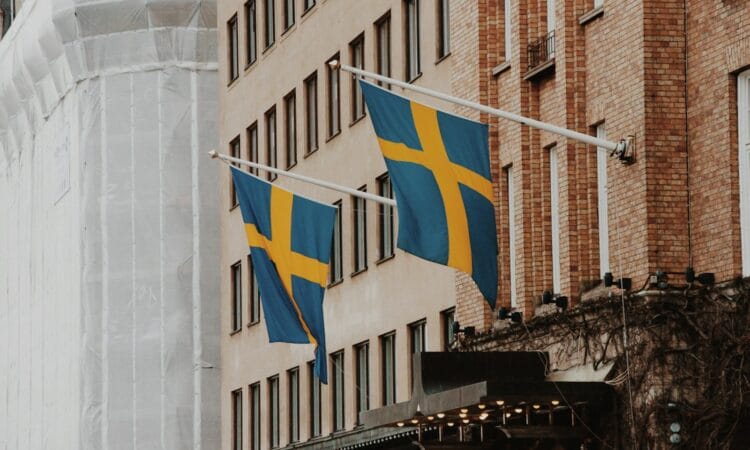a couple of flags hanging from the side of a building