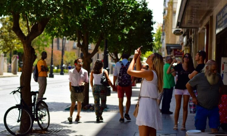 woman holding smartphone near man wearing gray t-shirt