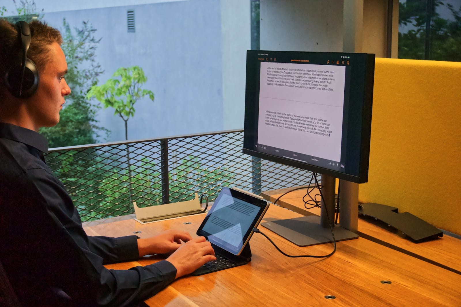 person in black long sleeve shirt using macbook pro on brown wooden table
