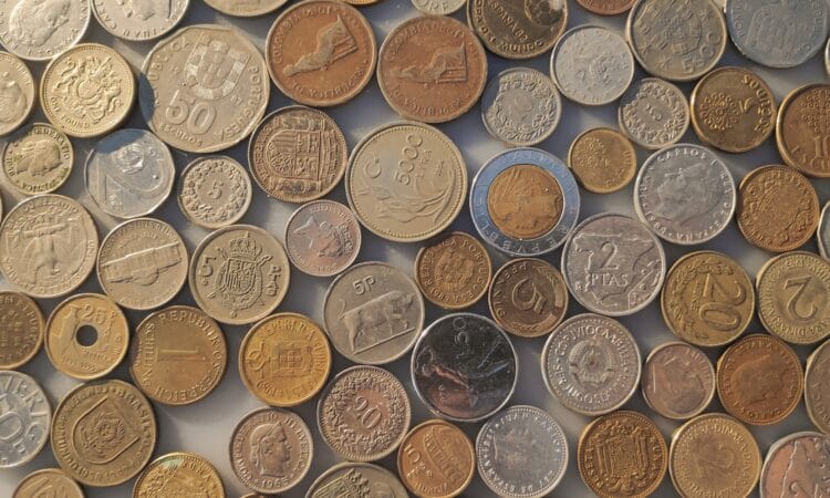 a pile of different coins sitting on top of each other