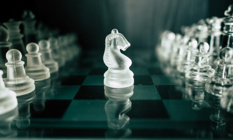 a glass chess board with a white horse on it