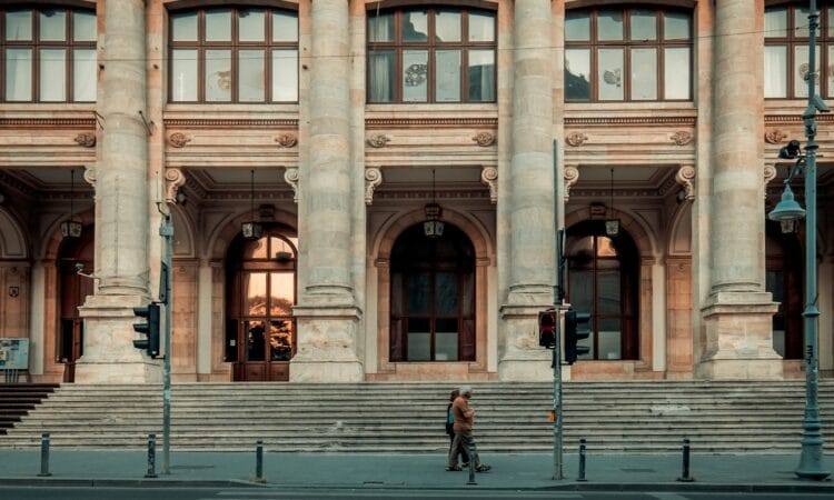 person walking pass building