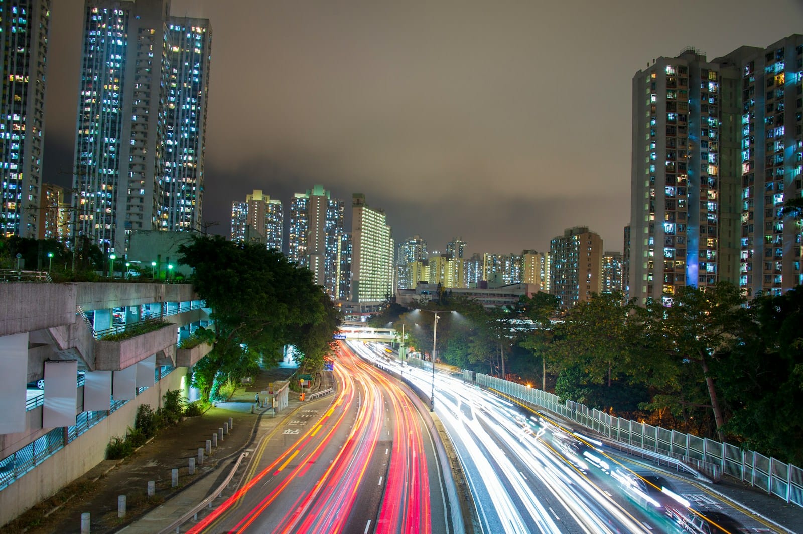 a city street filled with lots of traffic next to tall buildings
