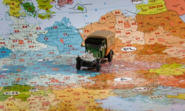 A toy truck travels across europe on a map.