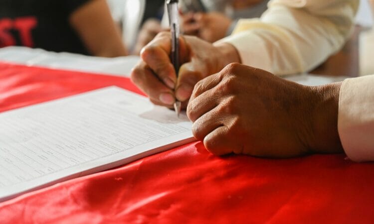 a person writing on a piece of paper