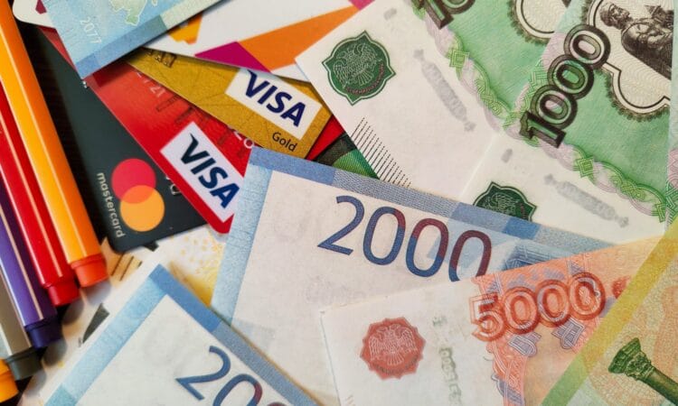 a pile of different currency sitting on top of each other