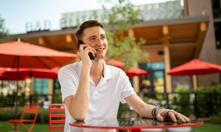 man in white crew neck t-shirt sitting on red bench