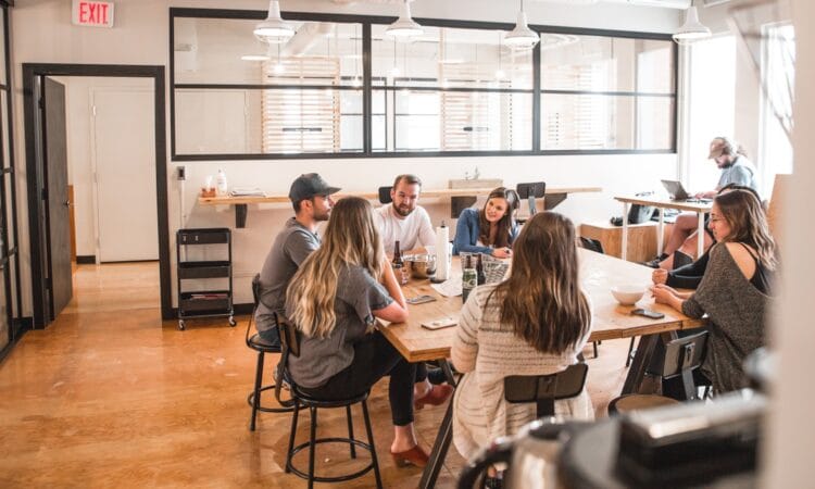 talking people sitting beside table